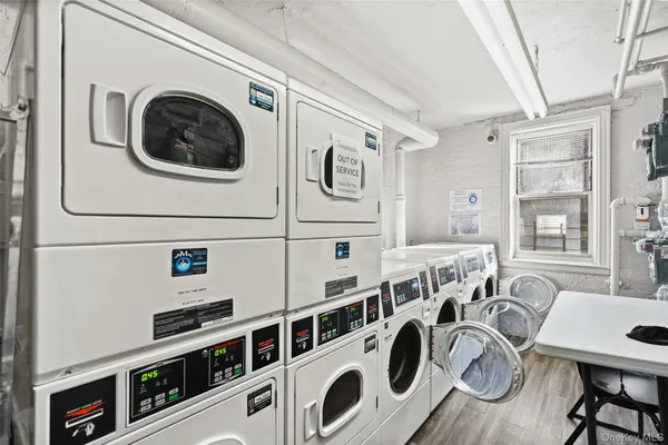 a utility room with multiple dryer and washer