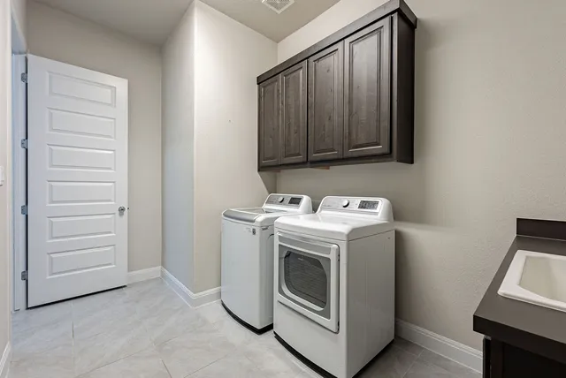 a front view of a house with garden and trees