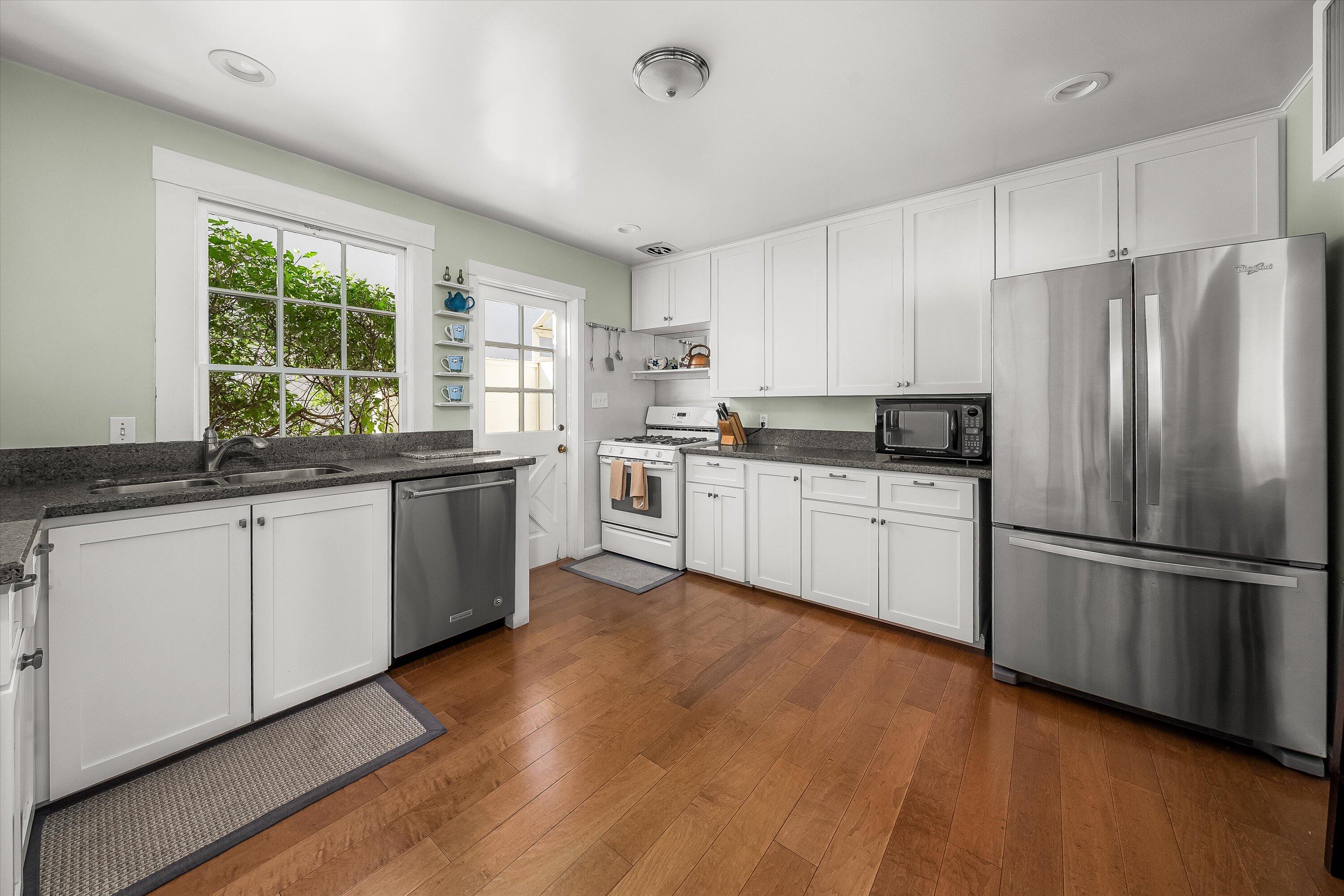 118 Chapala Street Santa Barbara, CA 93101 - Photo 15 of 46 a kitchen with a sink white cabinets and stainless steel appliances