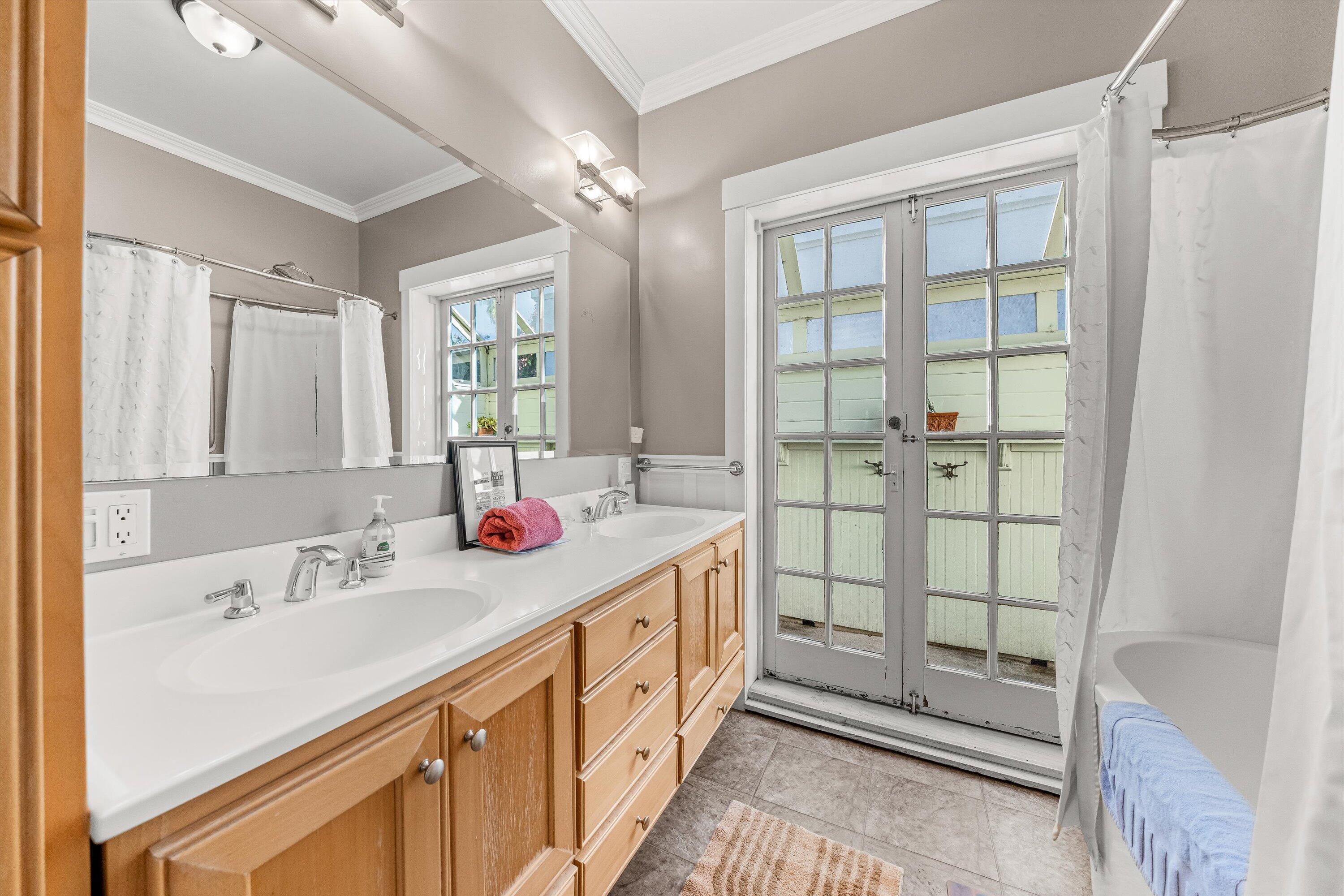 118 Chapala Street Santa Barbara, CA 93101 - Photo 18 of 46 a bathroom with double vanity and a sink