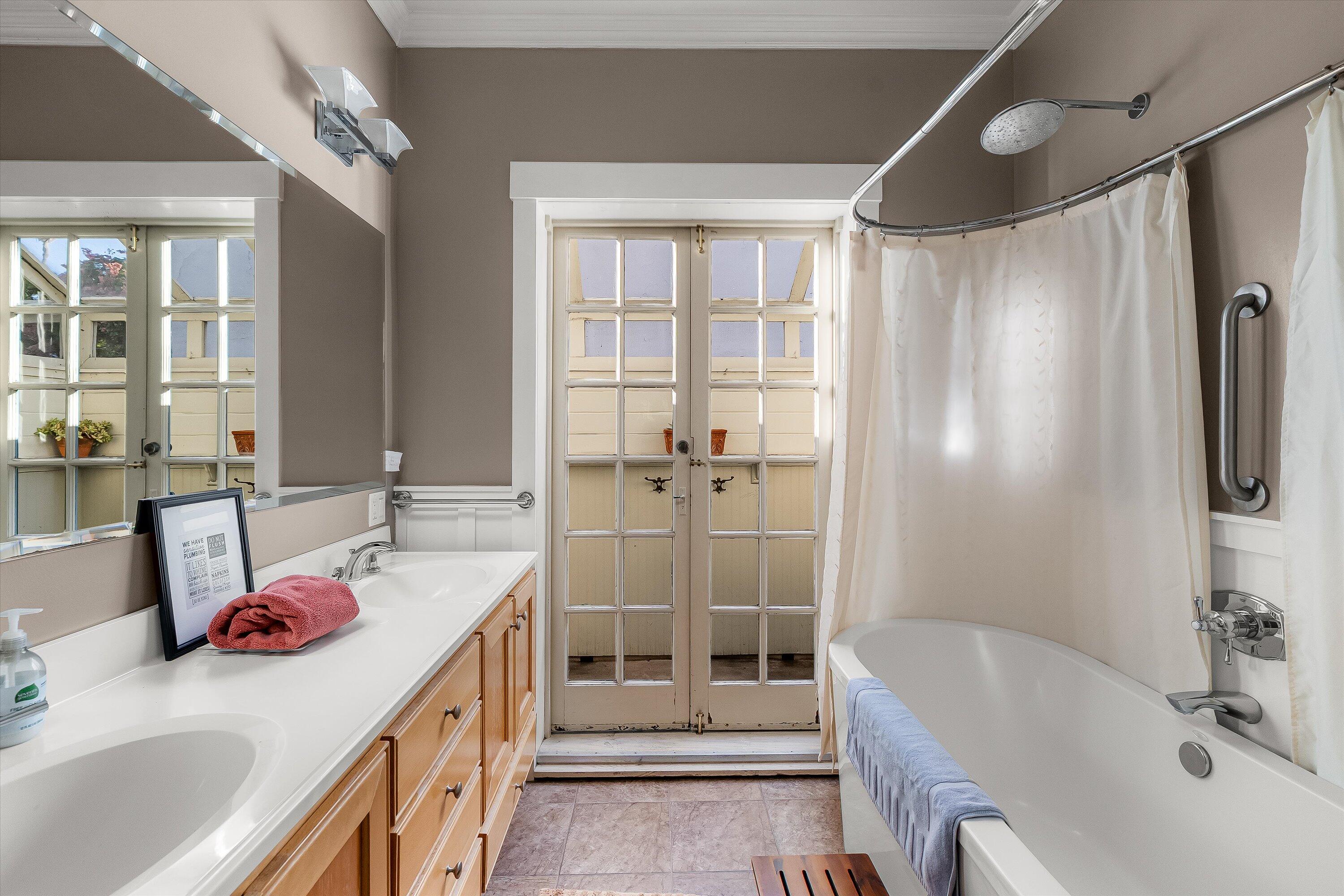 118 Chapala Street Santa Barbara, CA 93101 - Photo 19 of 46 a bathroom with a tub sink and shower