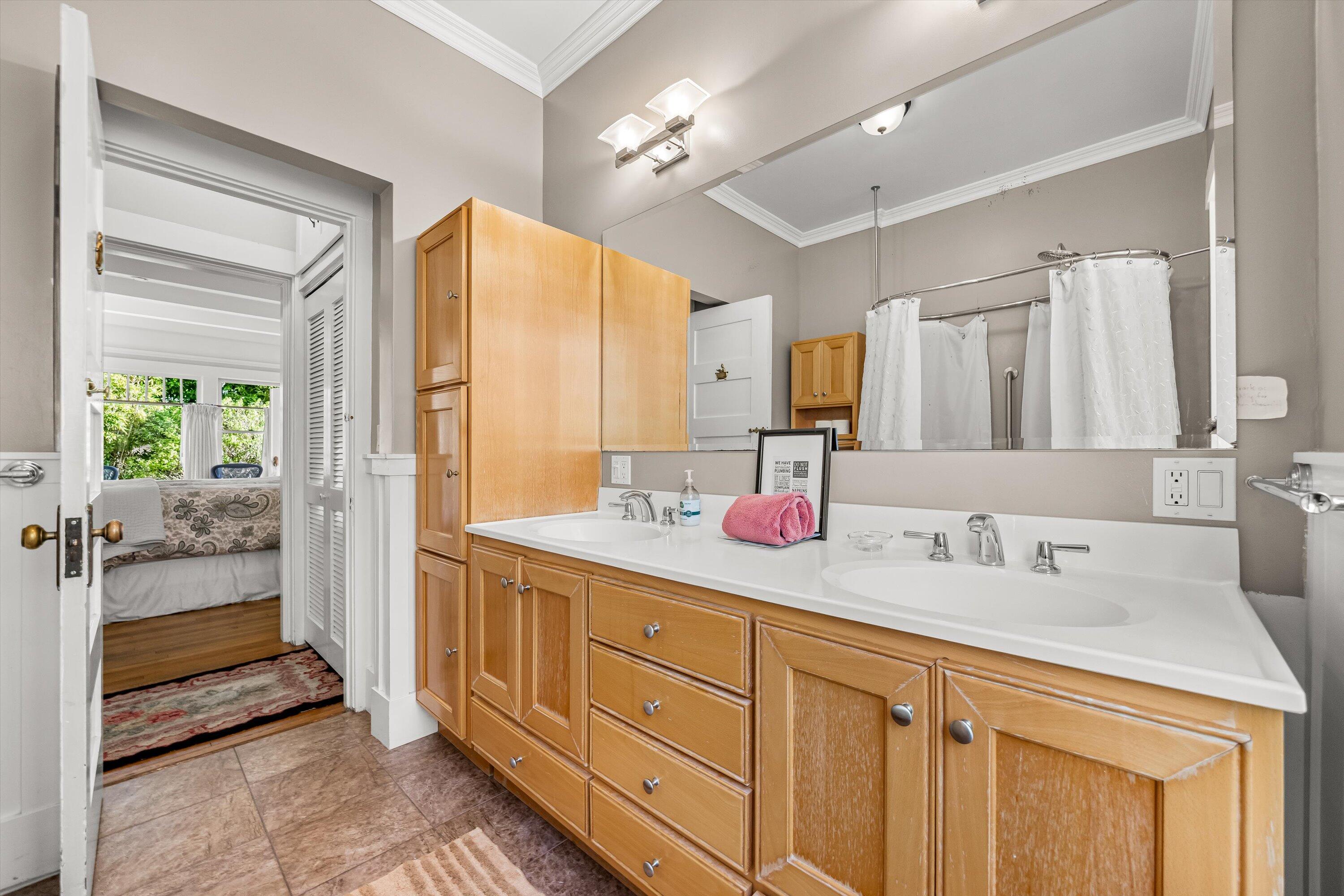 118 Chapala Street Santa Barbara, CA 93101 - Photo 20 of 46 a spacious bathroom with a double vanity sink a mirror and a shower