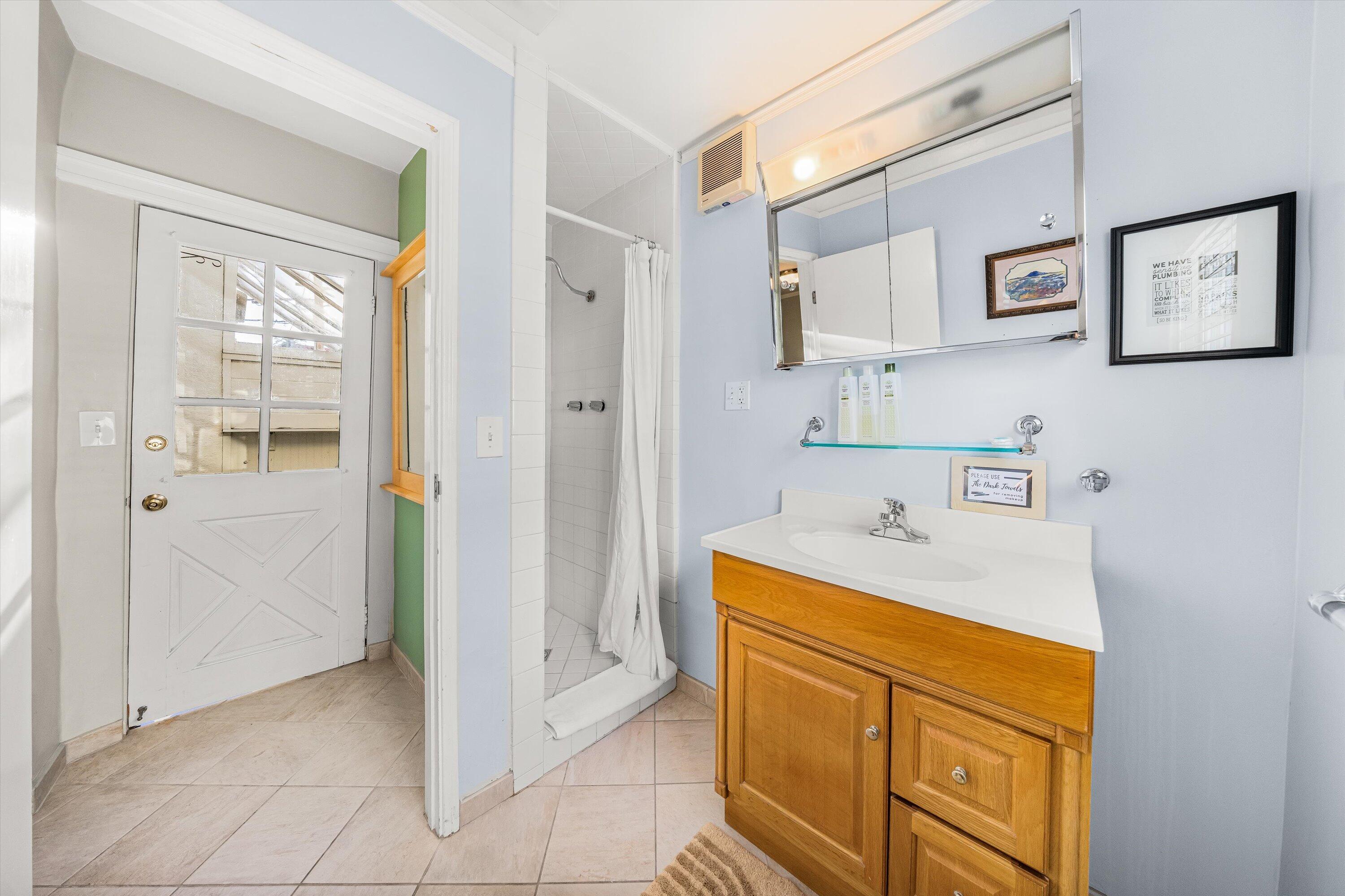 118 Chapala Street Santa Barbara, CA 93101 - Photo 24 of 46 a bathroom with a sink a vanity and a mirror
