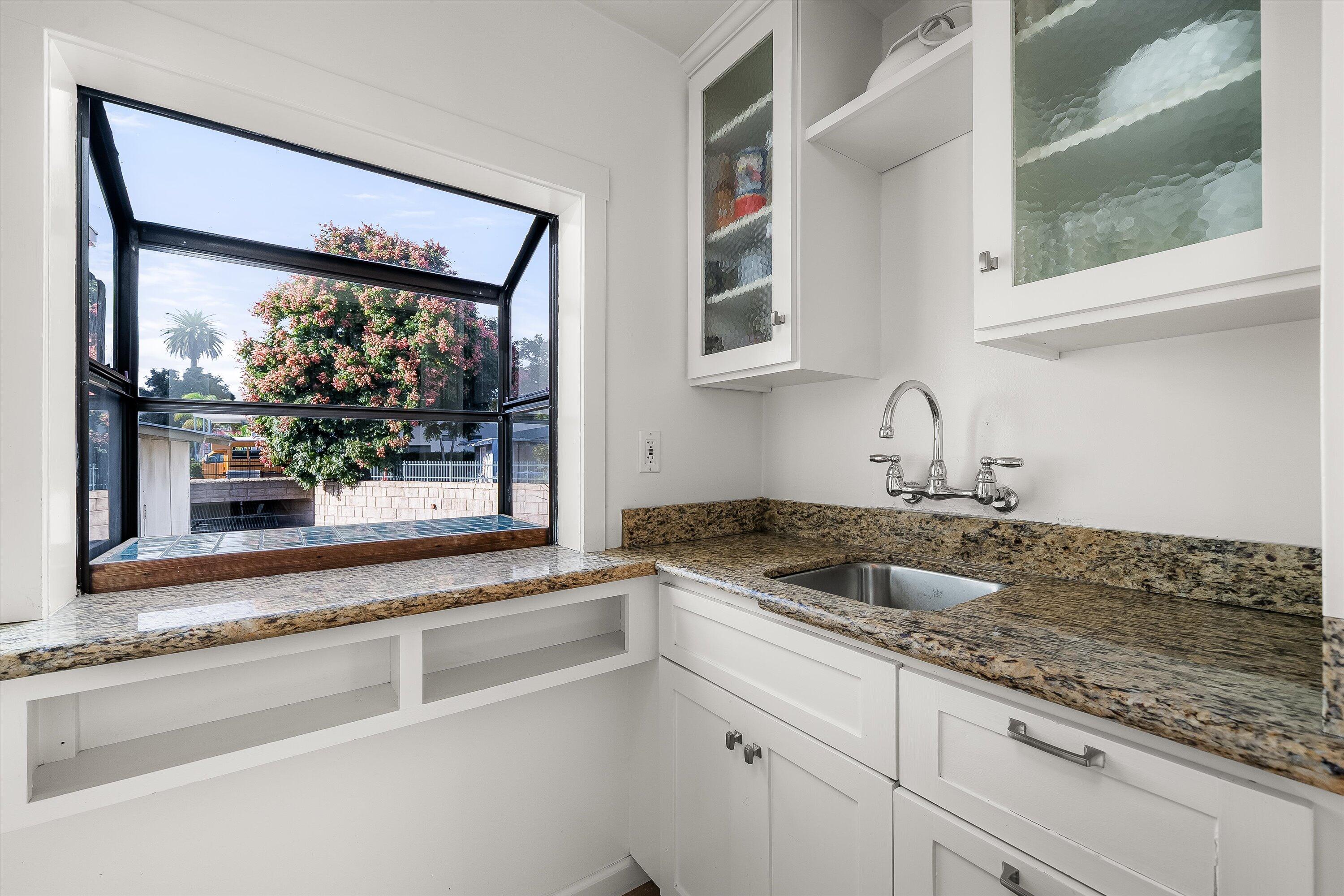 118 Chapala Street Santa Barbara, CA 93101 - Photo 26 of 46 a kitchen with granite countertop a sink and a window