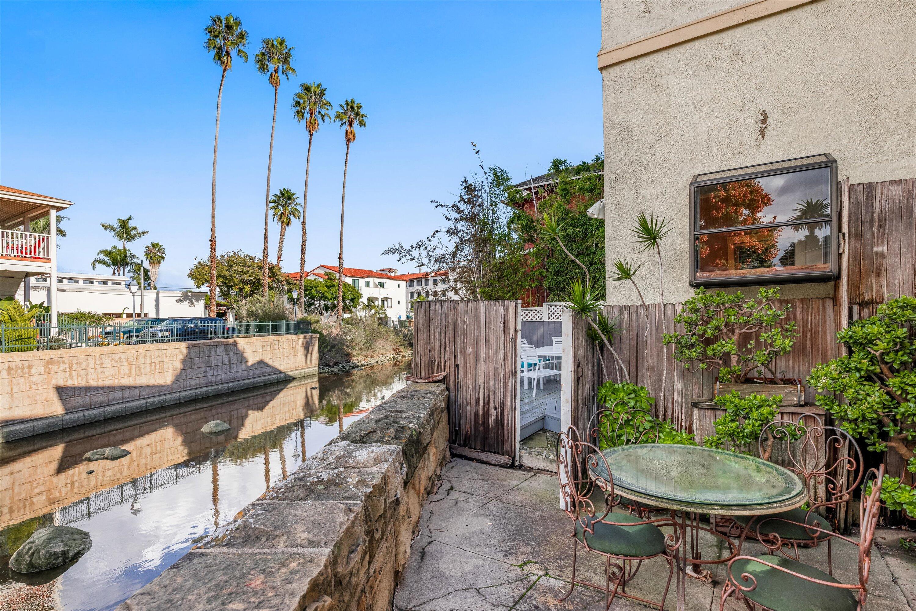 118 Chapala Street Santa Barbara, CA 93101 - Photo 32 of 46 a backyard of a house with table and chairs plants