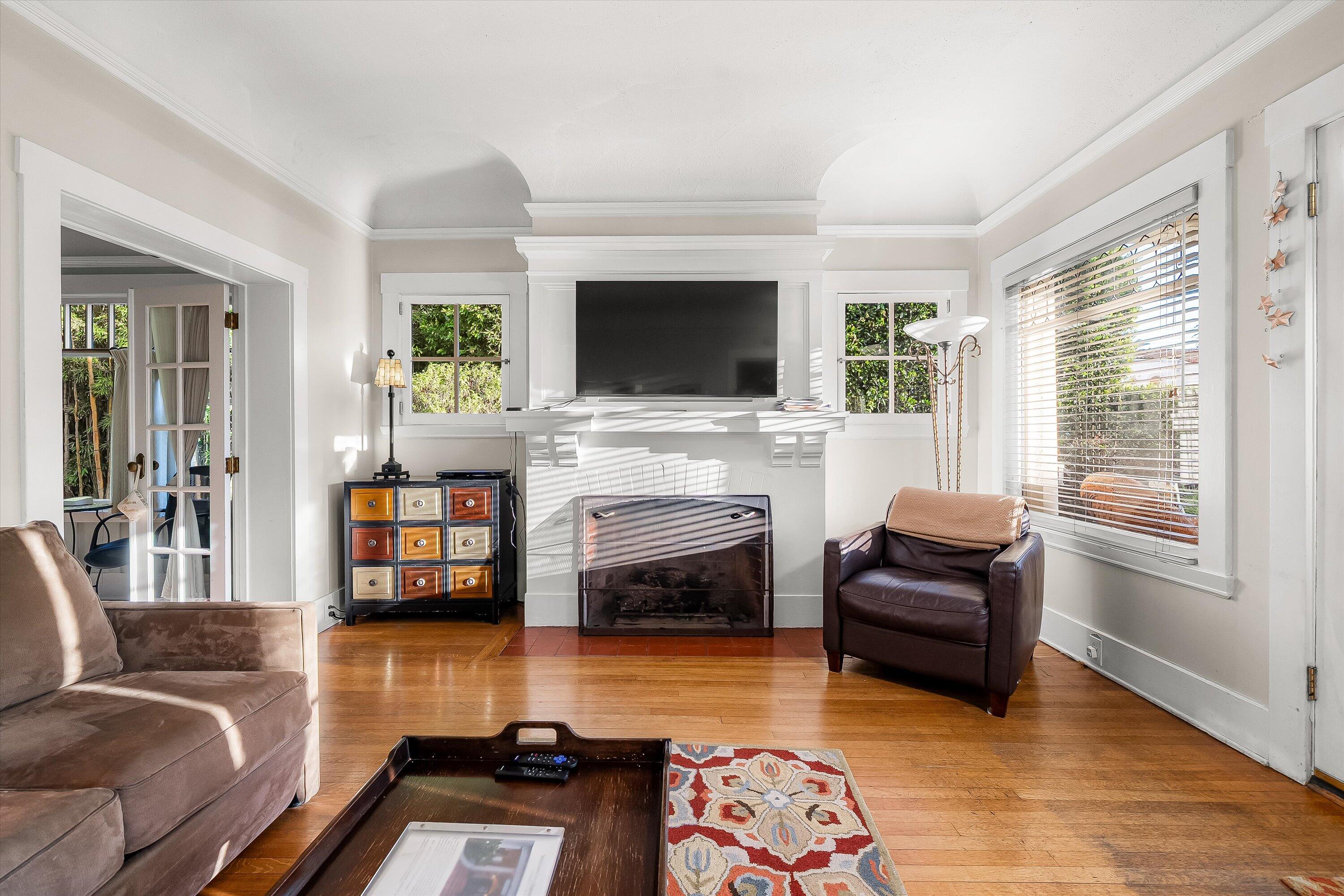 118 Chapala Street Santa Barbara, CA 93101 - Photo 5 of 46 a living room with furniture a flat screen tv and a fireplace