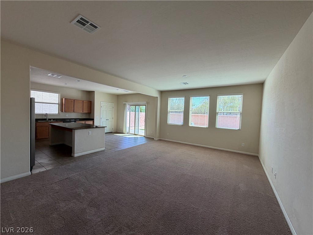 442 White Heart Road Las Vegas, NV 89148 - Photo 25 of 25 An open floor plan connects the carpeted living space to the adjacent kitchen.