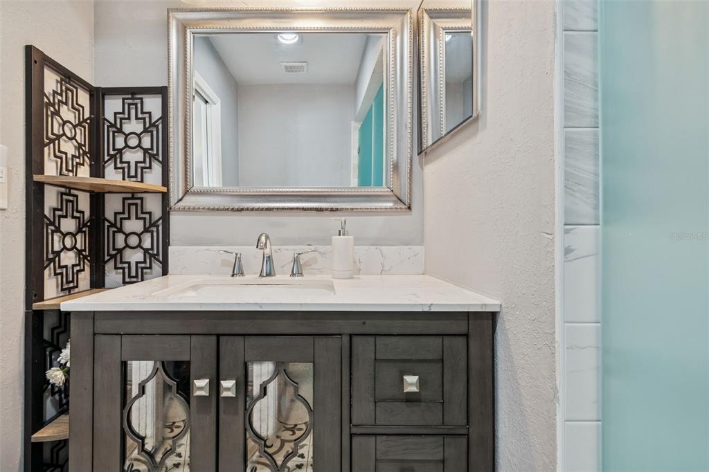 330 6th Avenue Indian Rocks Beach, FL 33785 - Photo 18 of 52 a bathroom with a sink and a mirror