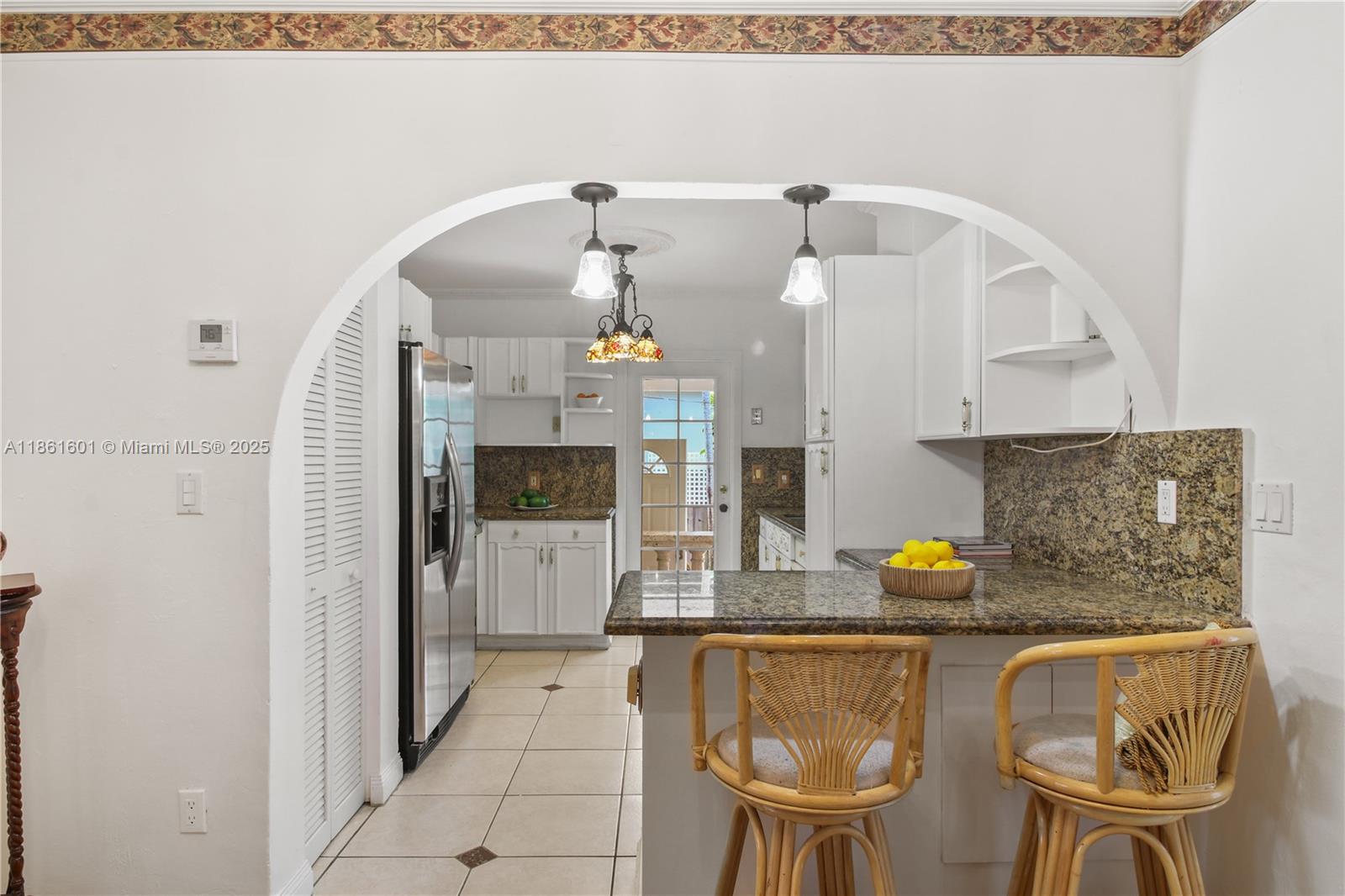 6101 Southwest 13th Terrace West Miami, FL 33144 - Photo 12 of 47 a kitchen with a sink cabinets and chandelier