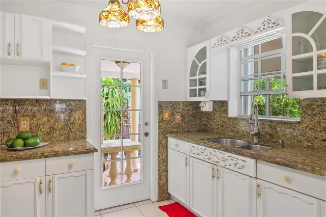 a kitchen with stainless steel appliances granite countertop a sink and a granite counter tops