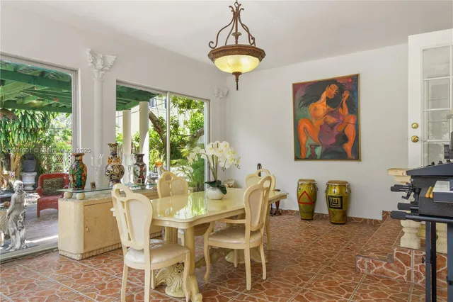 a dining room with furniture a window and a chandelier
