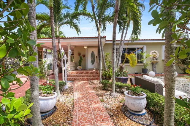 a view of a backyard with garden and plants