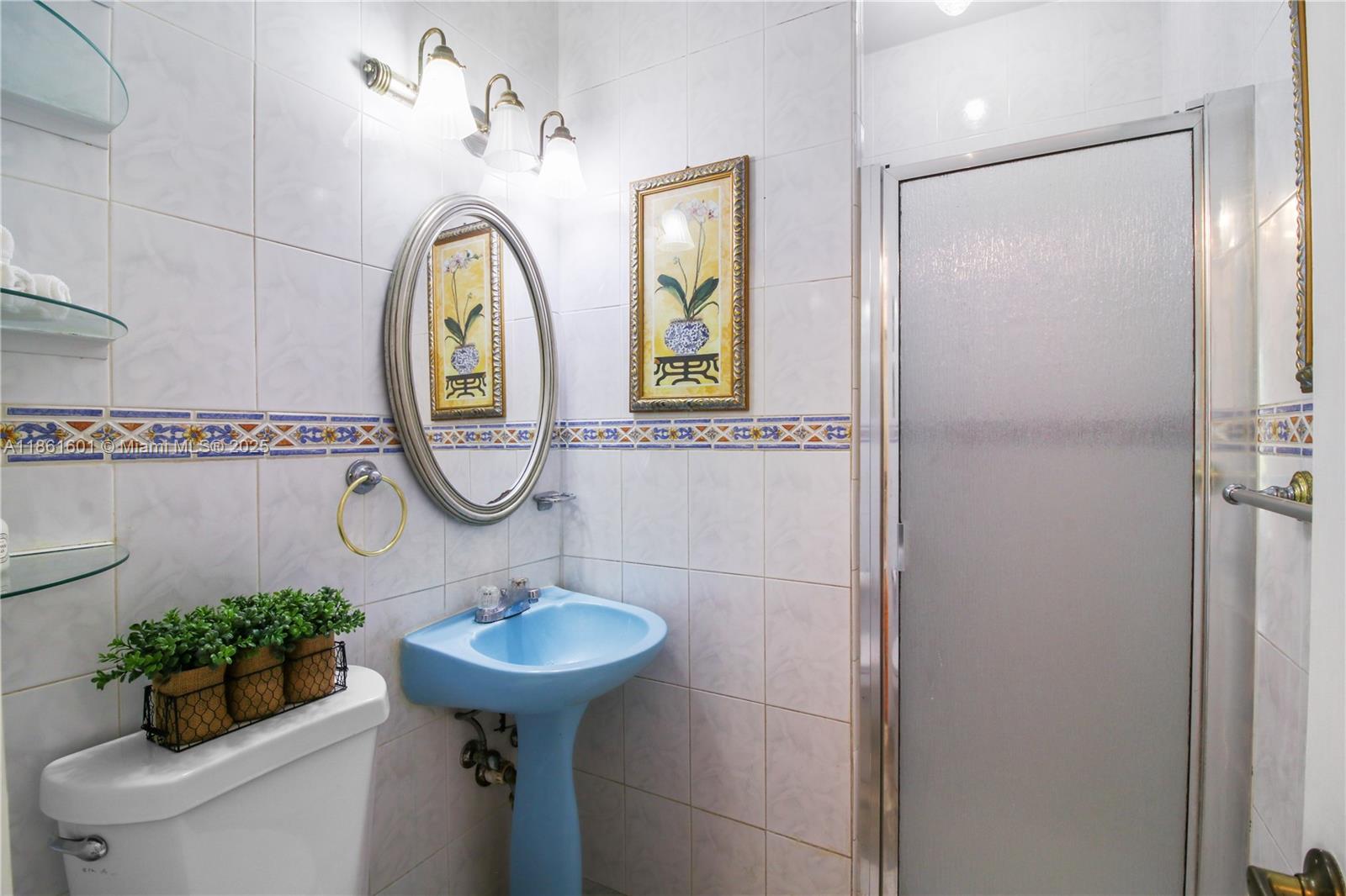 6101 Southwest 13th Terrace West Miami, FL 33144 - Photo 24 of 47 a bathroom with a sink mirror and toilet