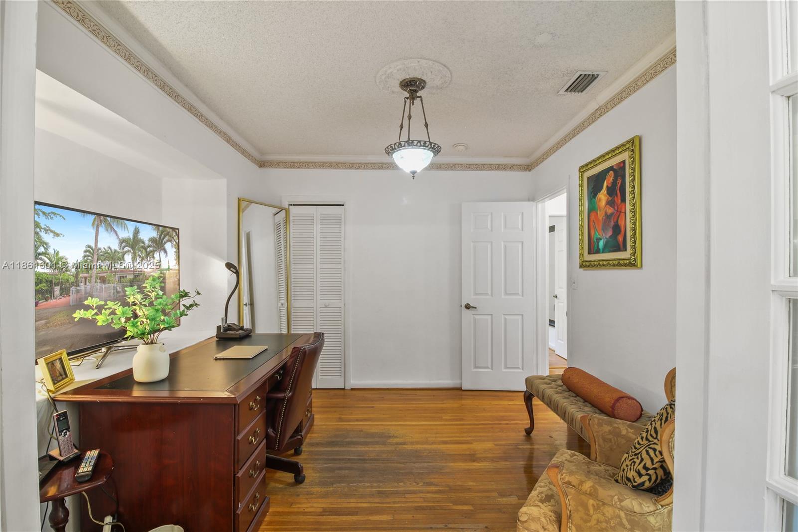 6101 Southwest 13th Terrace West Miami, FL 33144 - Photo 27 of 47 a bedroom with furniture and a window