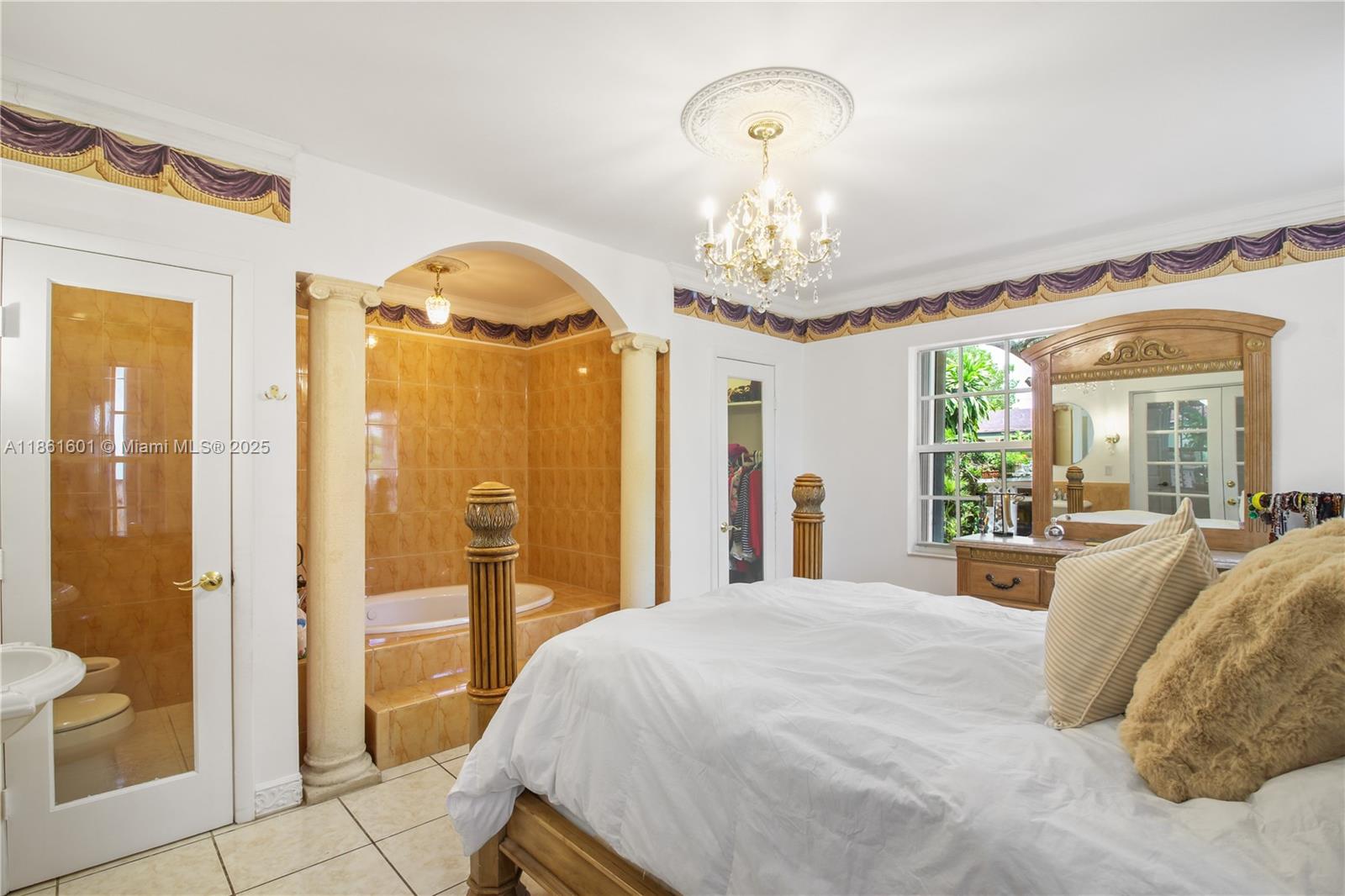 6101 Southwest 13th Terrace West Miami, FL 33144 - Photo 29 of 47 a spacious bedroom with a bed and a chandelier