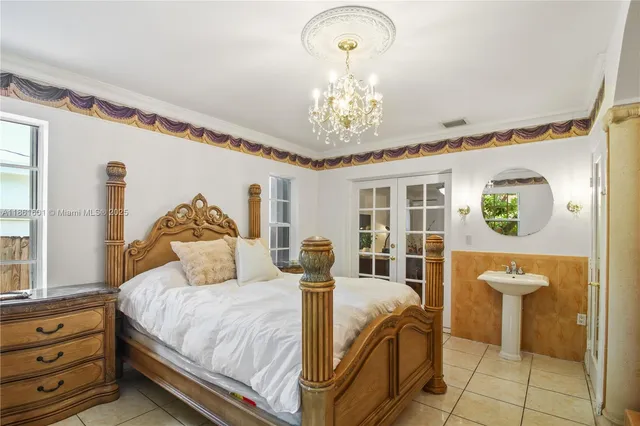 a bedroom with a bed and a chandelier