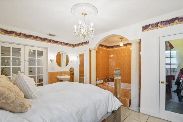 a bedroom with a bed and dresser with mirror