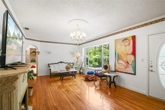 a living room with furniture and a chandelier
