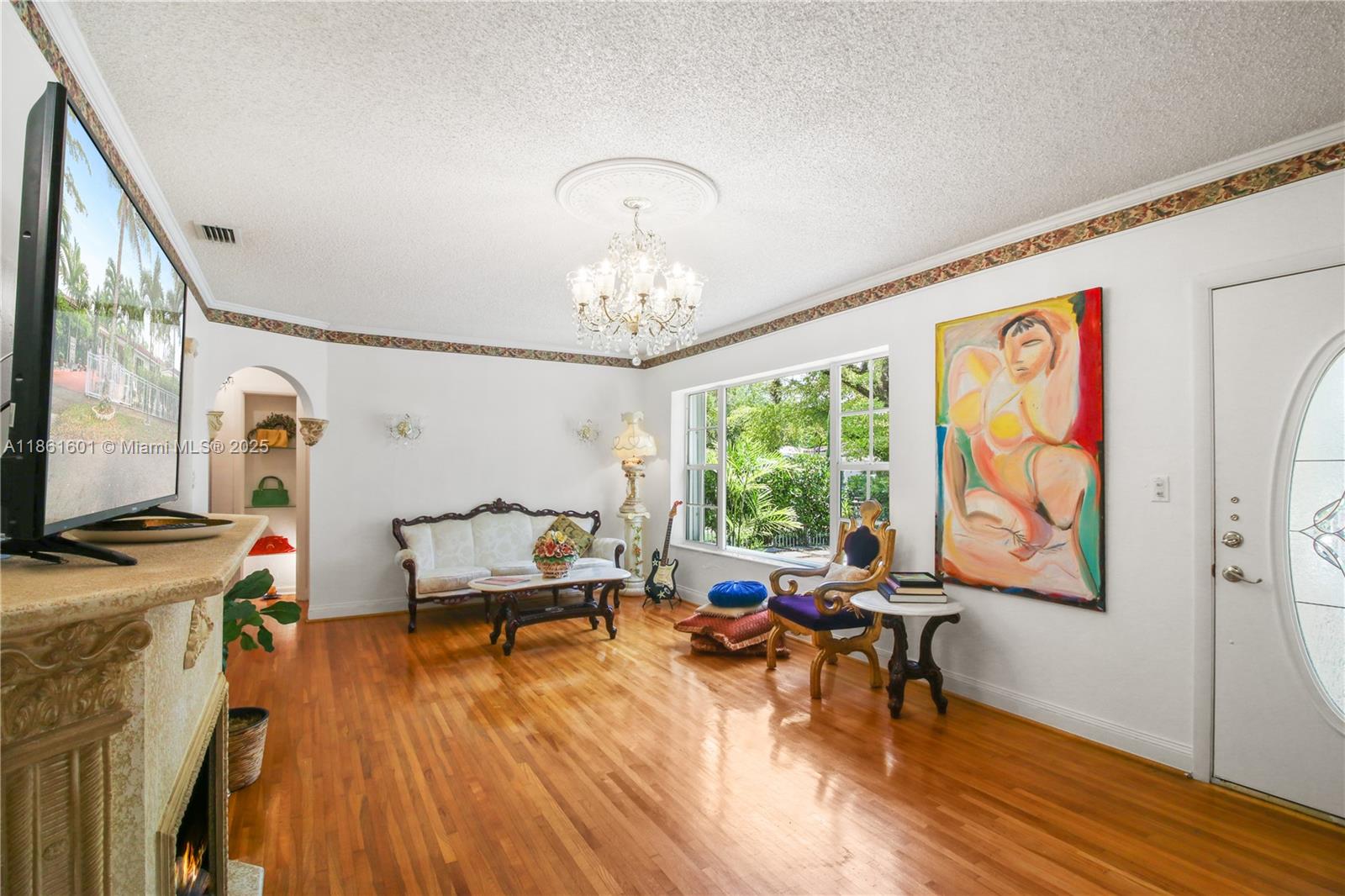 6101 Southwest 13th Terrace West Miami, FL 33144 - Photo 6 of 47 a living room with furniture and a chandelier