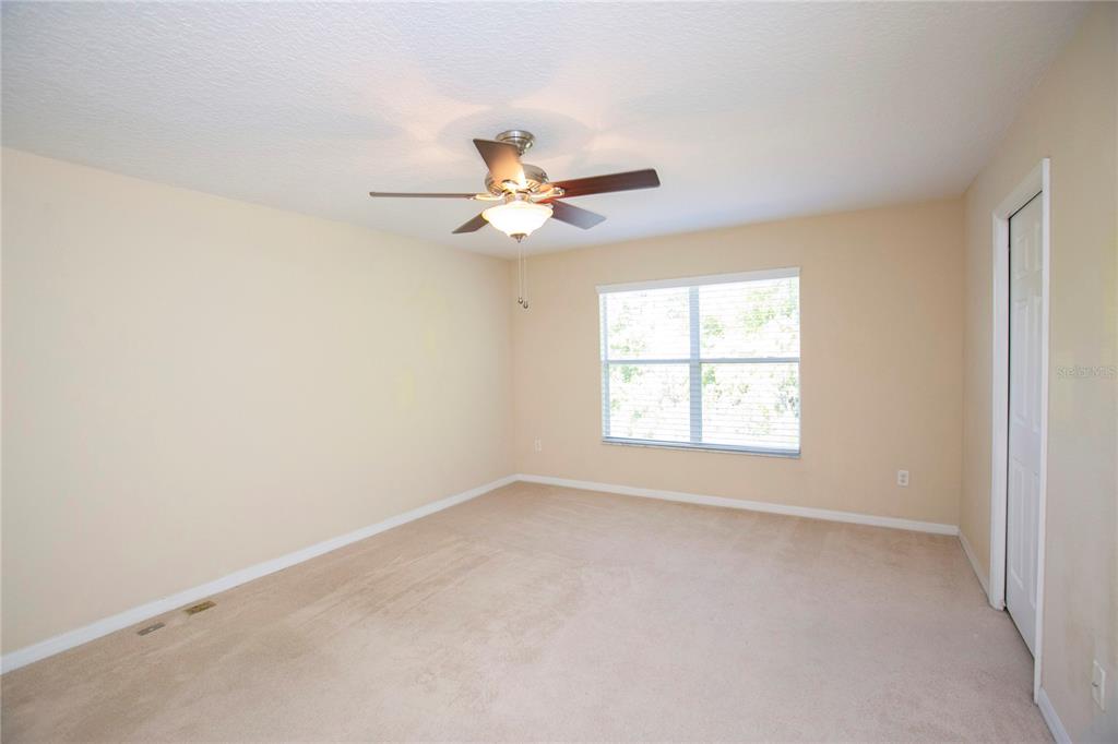 11919 Essington Street New Port Richey, FL 34654 - Photo 15 of 46 an empty room with a window and a fan