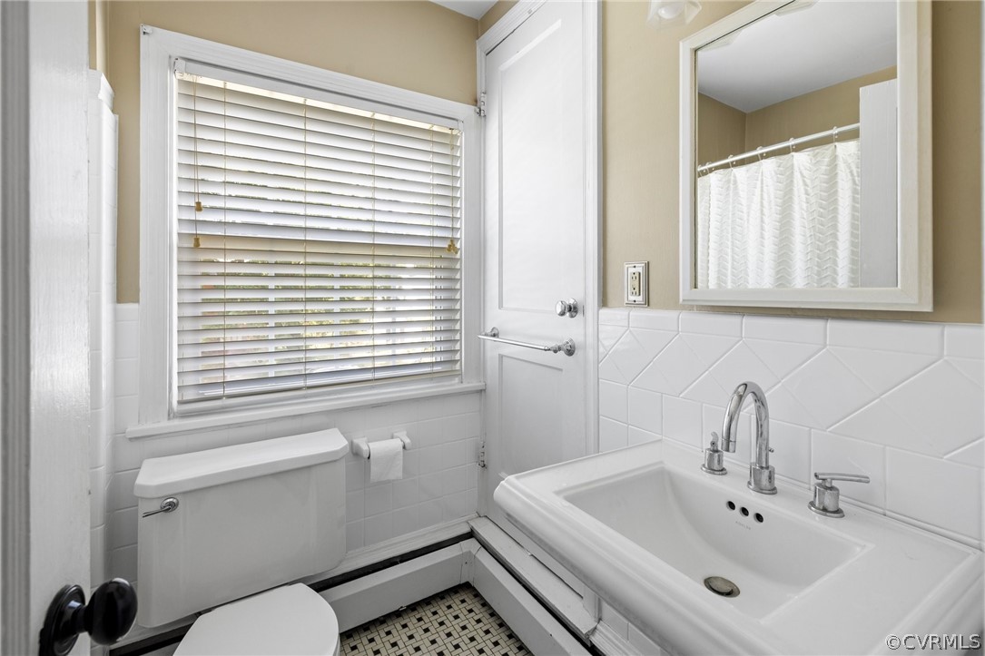 1003 Bevridge Road Richmond, VA 23226 - Photo 17 of 29 a bathroom with a sink a toilet and a mirror