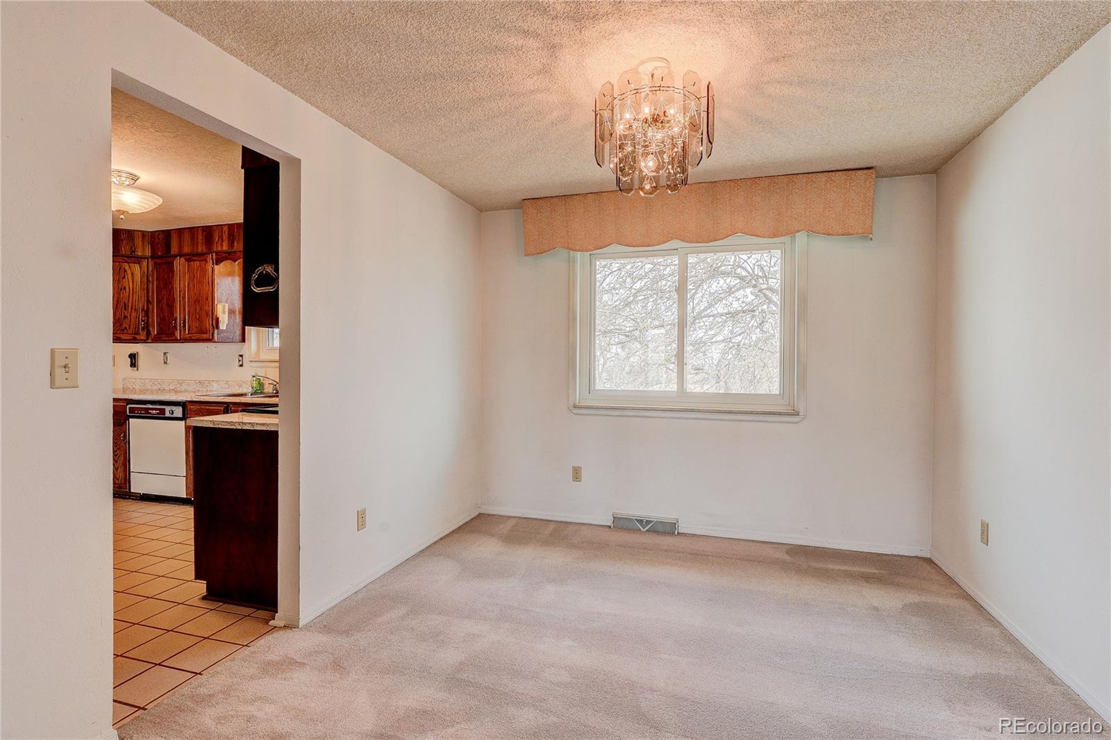 806 Cole Street Golden, CO 80401 - Photo 12 of 36 en empty room with windows and chandelier