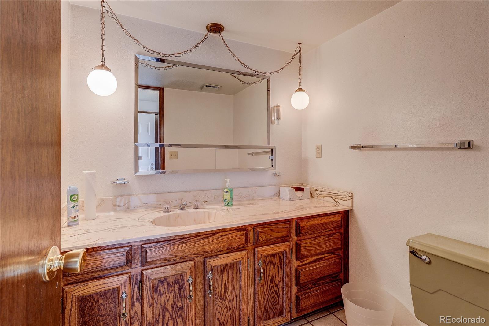 806 Cole Street Golden, CO 80401 - Photo 17 of 36 a bathroom with a sink vanity granite and toilet