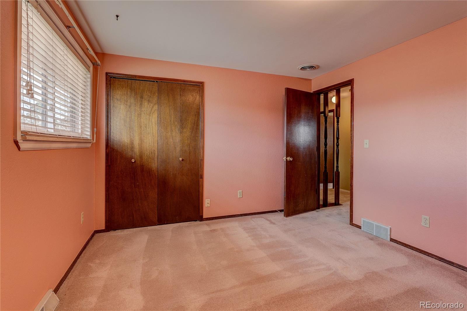 806 Cole Street Golden, CO 80401 - Photo 18 of 36 an empty room with windows and closet