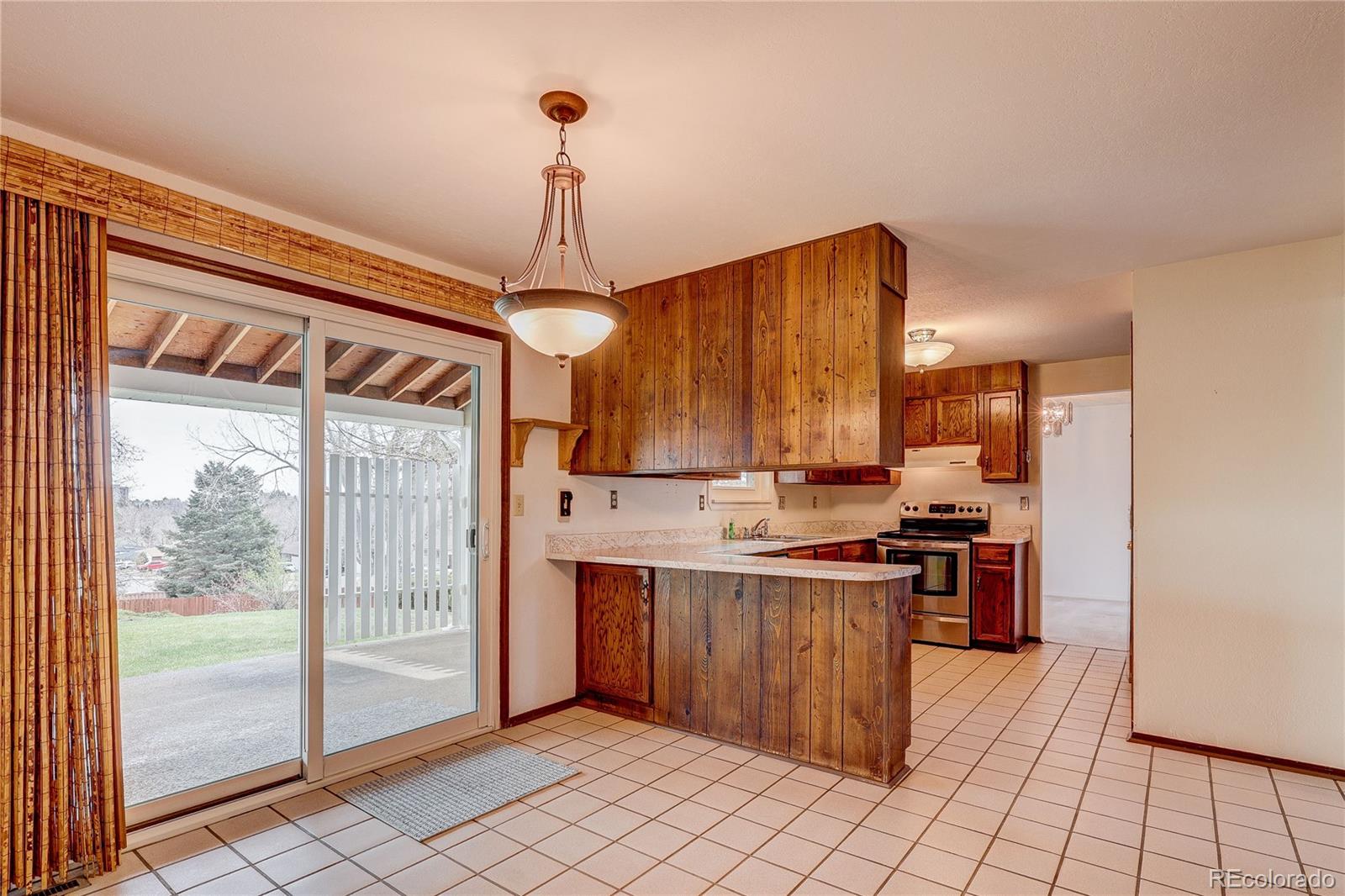 806 Cole Street Golden, CO 80401 - Photo 4 of 36 a kitchen with stainless steel appliances granite countertop a stove a sink dishwasher and a refrigerator with wooden floor