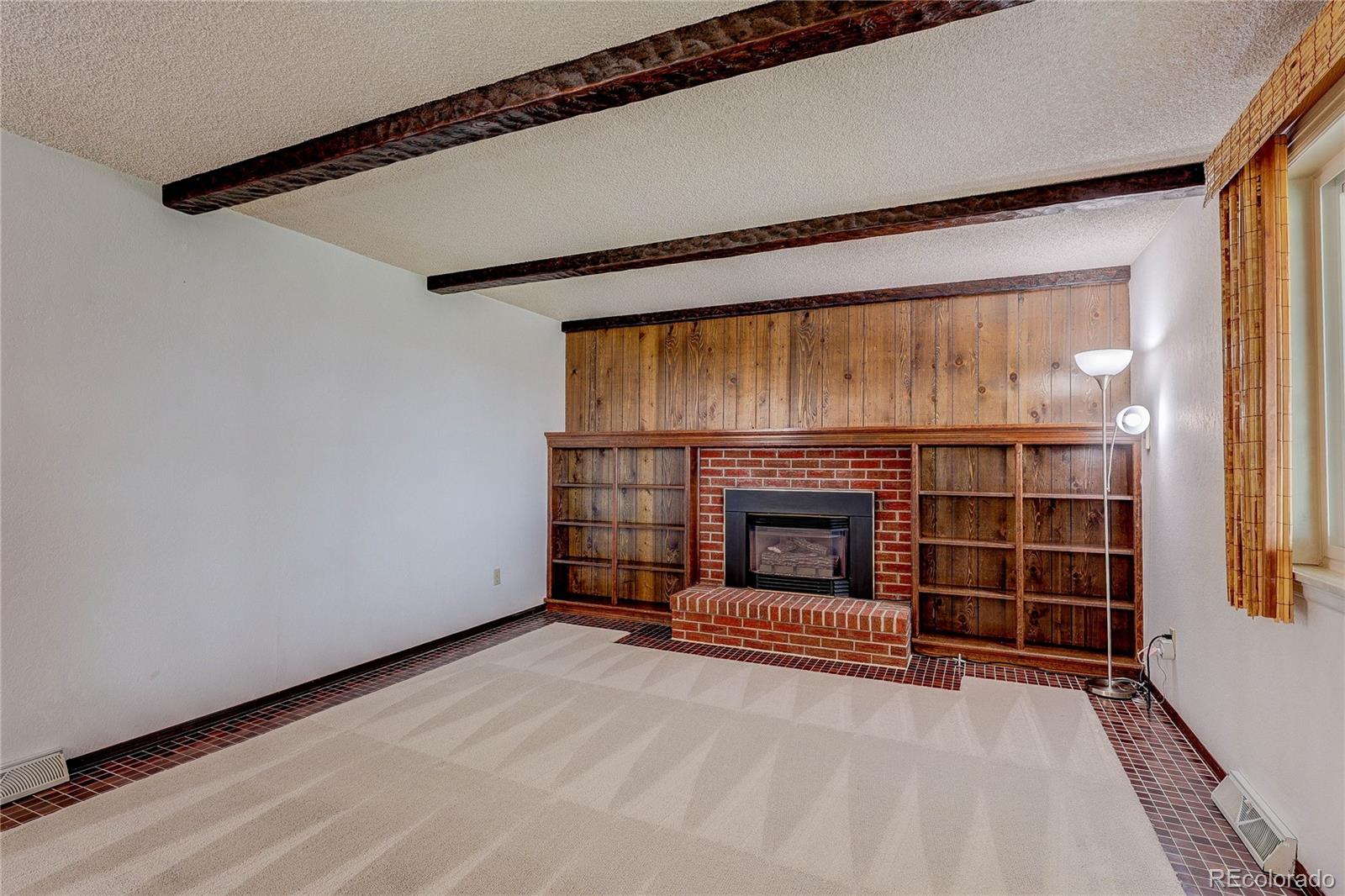 806 Cole Street Golden, CO 80401 - Photo 7 of 36 a view of an empty room with a fireplace and a window
