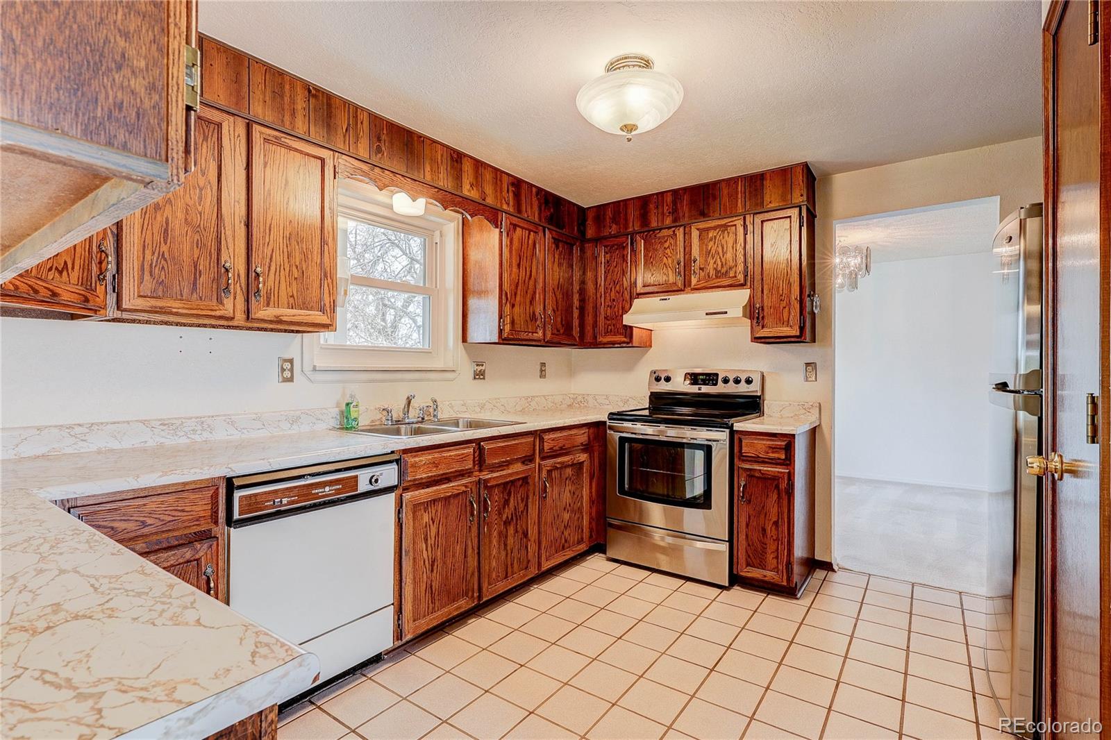 806 Cole Street Golden, CO 80401 - Photo 8 of 36 a kitchen with stainless steel appliances granite countertop a stove sink and cabinets