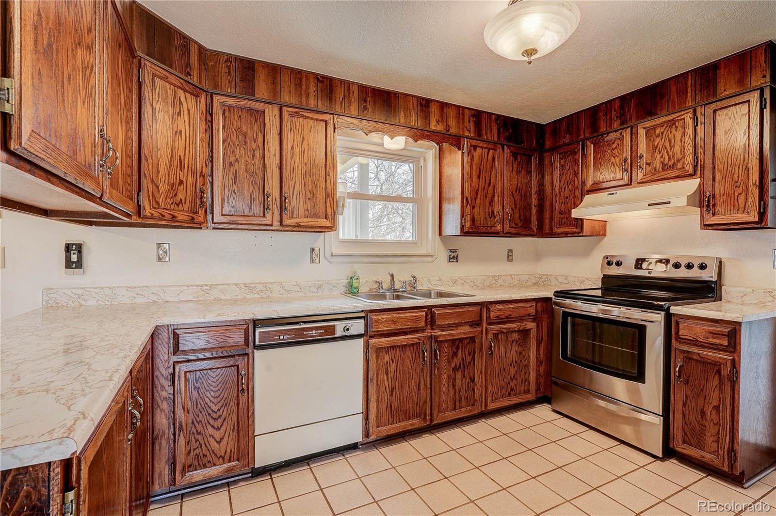 806 Cole Street Golden, CO 80401 - Photo 9 of 36 a kitchen with stainless steel appliances granite countertop a stove sink and cabinets