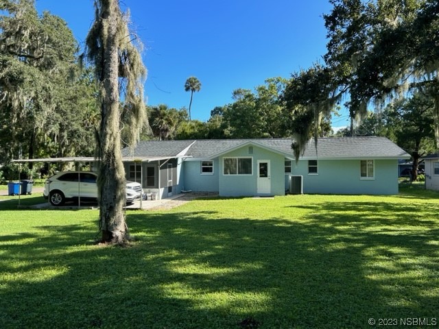 795 Biro Drive Port Orange, FL 32129 - Photo 3 of 26 a front view of a house with a yard and trees