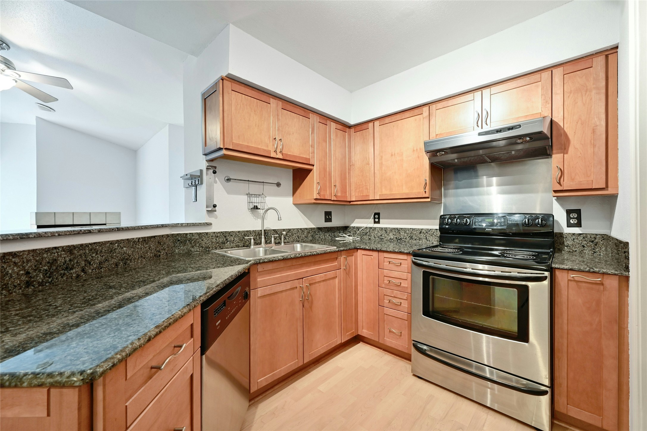 2450 Wickersham Lane, Unit 710 Austin, TX 78741 - Photo 1 of 20 a kitchen with granite countertop a stove sink and cabinets
