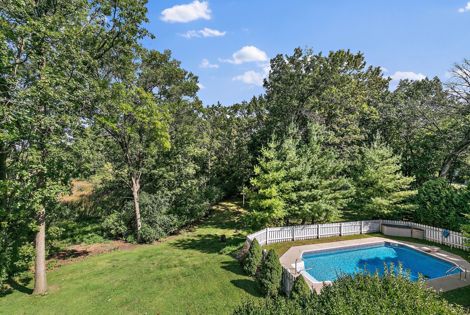 5305 North Ridgeway Road Ringwood, IL 60072 - Photo 22 of 27 a view of a swimming pool and trees in the background