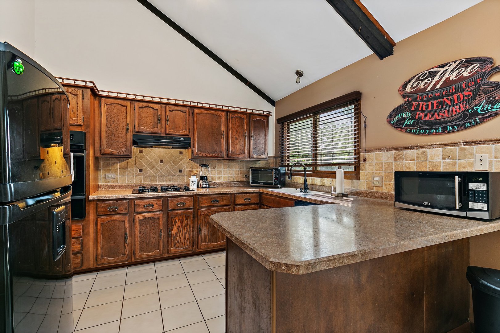 5305 North Ridgeway Road Ringwood, IL 60072 - Photo 9 of 27 a kitchen with stainless steel appliances granite countertop a sink a stove and a microwave