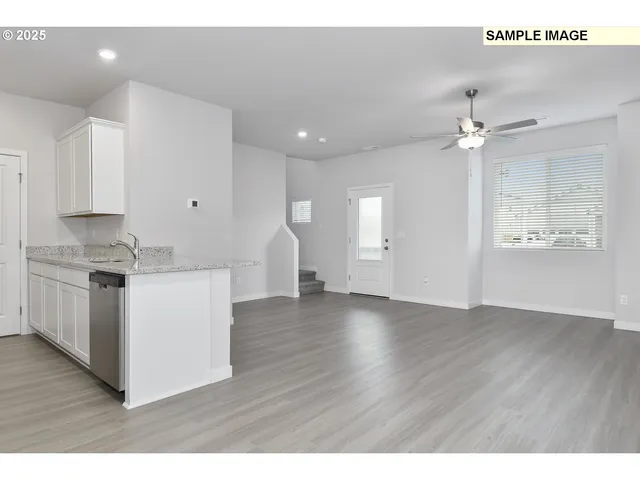 a view of kitchen with sink and wooden floor