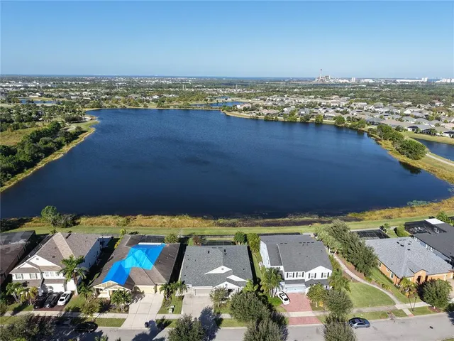 a kitchen with stainless steel appliances granite countertop a kitchen island a stove a table and chairs