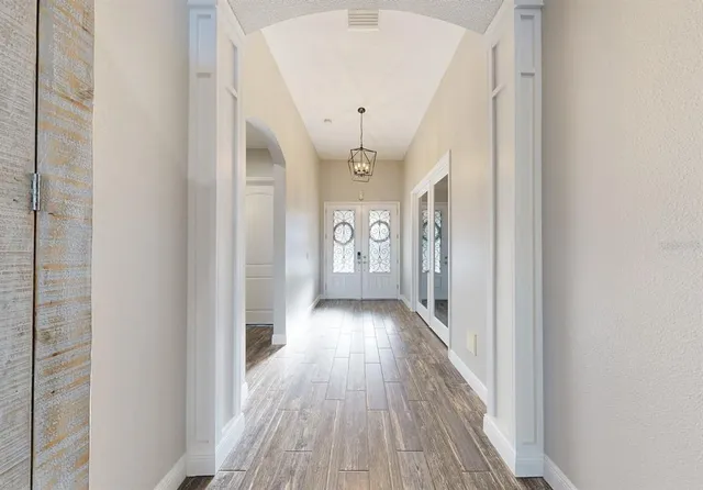 a kitchen with stainless steel appliances kitchen island granite countertop a refrigerator a stove and a sink