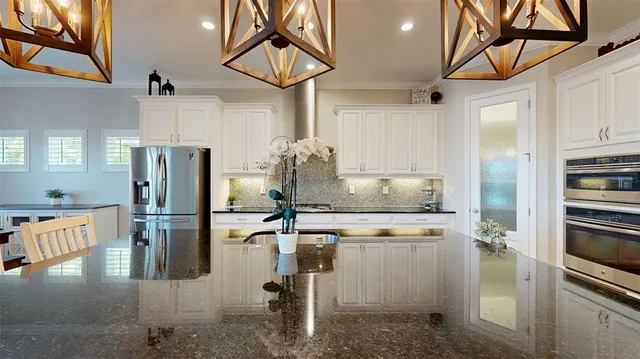 an aerial view of a house with a yard and lake view