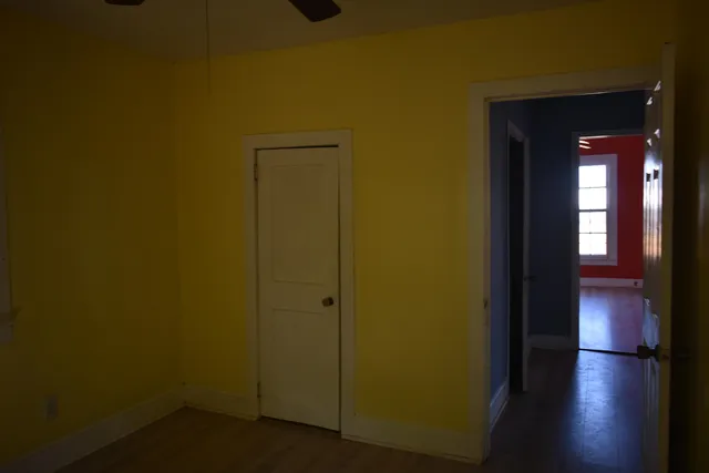 a view of a hallway with wooden floor