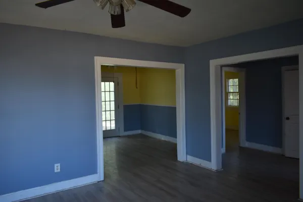 an empty room with wooden floor and closet