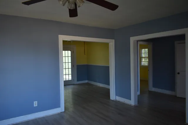 an empty room with wooden floor and closet