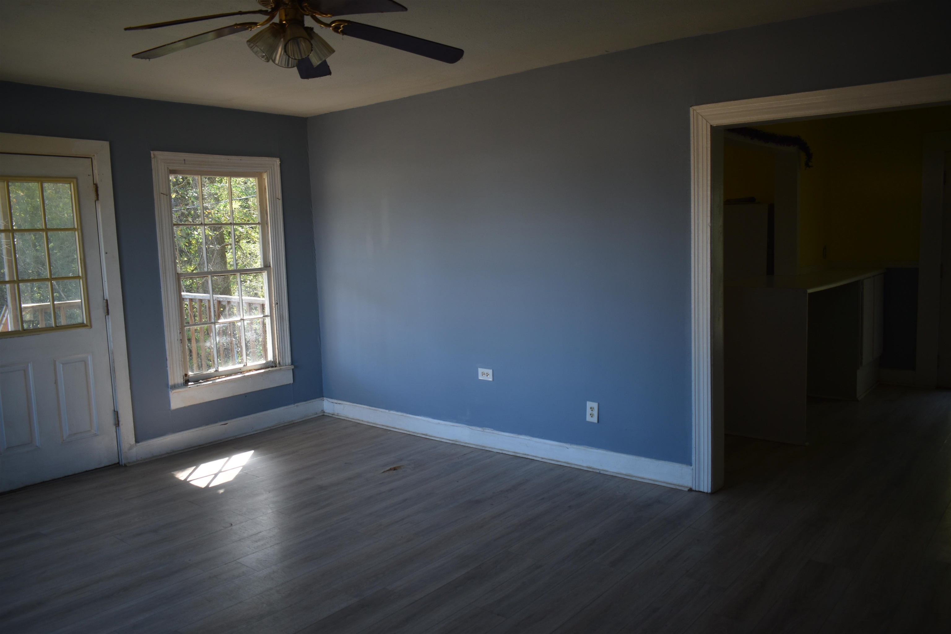 6907 45th Highway Ramer, TN 38367 - Photo 3 of 17 Unfurnished room with dark wood-type flooring and ceiling fan