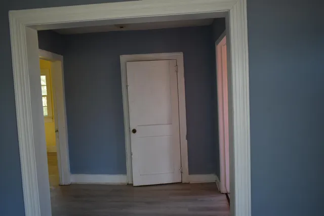 a view of a hallway with wooden floor