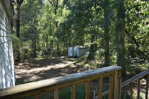 a view of a wooden house with a tree