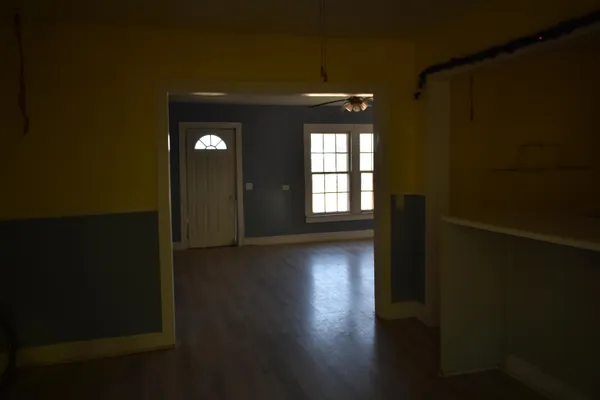 a view of a room with wooden floor and windows