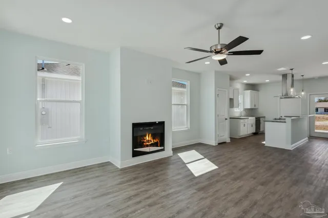 a view of a kitchen with wooden floor and a kitchen