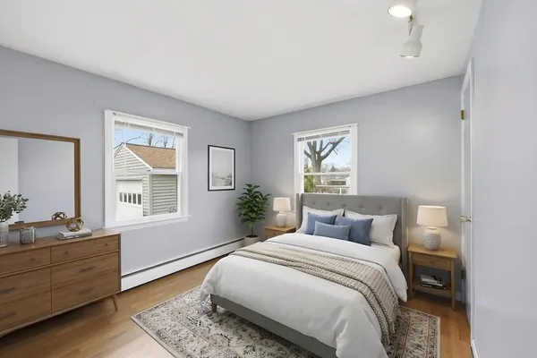 a bedroom with a bed and wooden floor