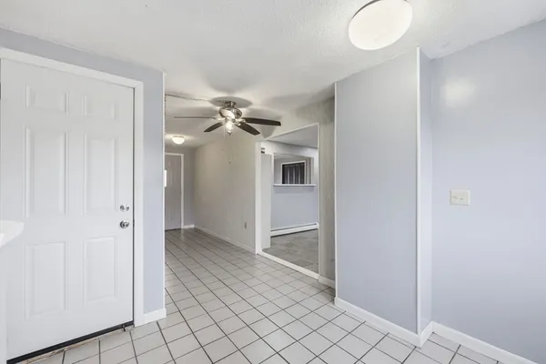 a view of a chandelier fan and entryway